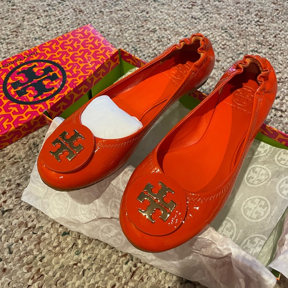 Tory Burch flats for sale in the color orange. Size 7.